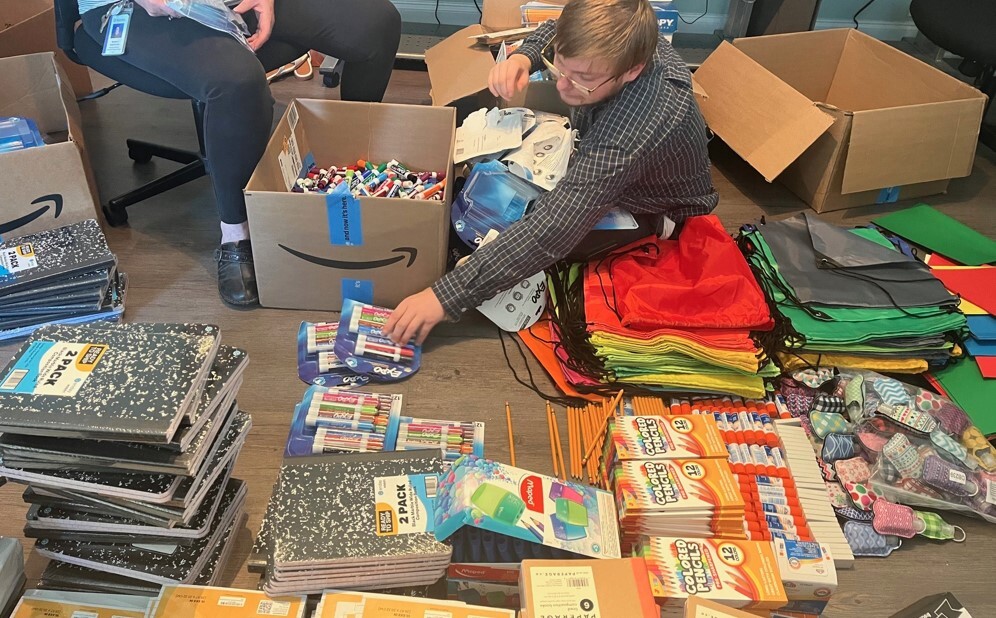 People organizing school supplies for the back to school bash.