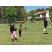 Parents were assisting their toddlers in finding Easter eggs.