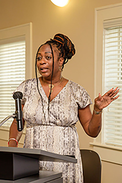 Della Robinson speaking at the podium