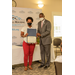 Nadia McClure accepts award from Dewayne Alford