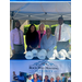 A group of men and women smiling while standing behind hardhats and a table with a tablecloth that reads Rock Hill Housing Authority.