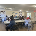 A group of people having lunch while listening to a speaker at the 2025 Fall Festival.