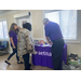 People looking at the table full of information and possible prizes for the 2025 Fall Festival.